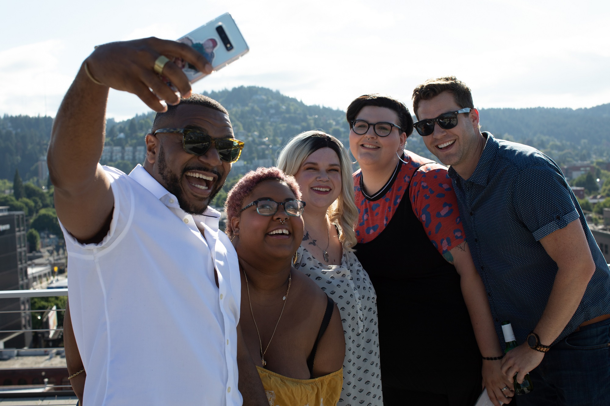 Diverse group of friends taking selfie in front of mountain view