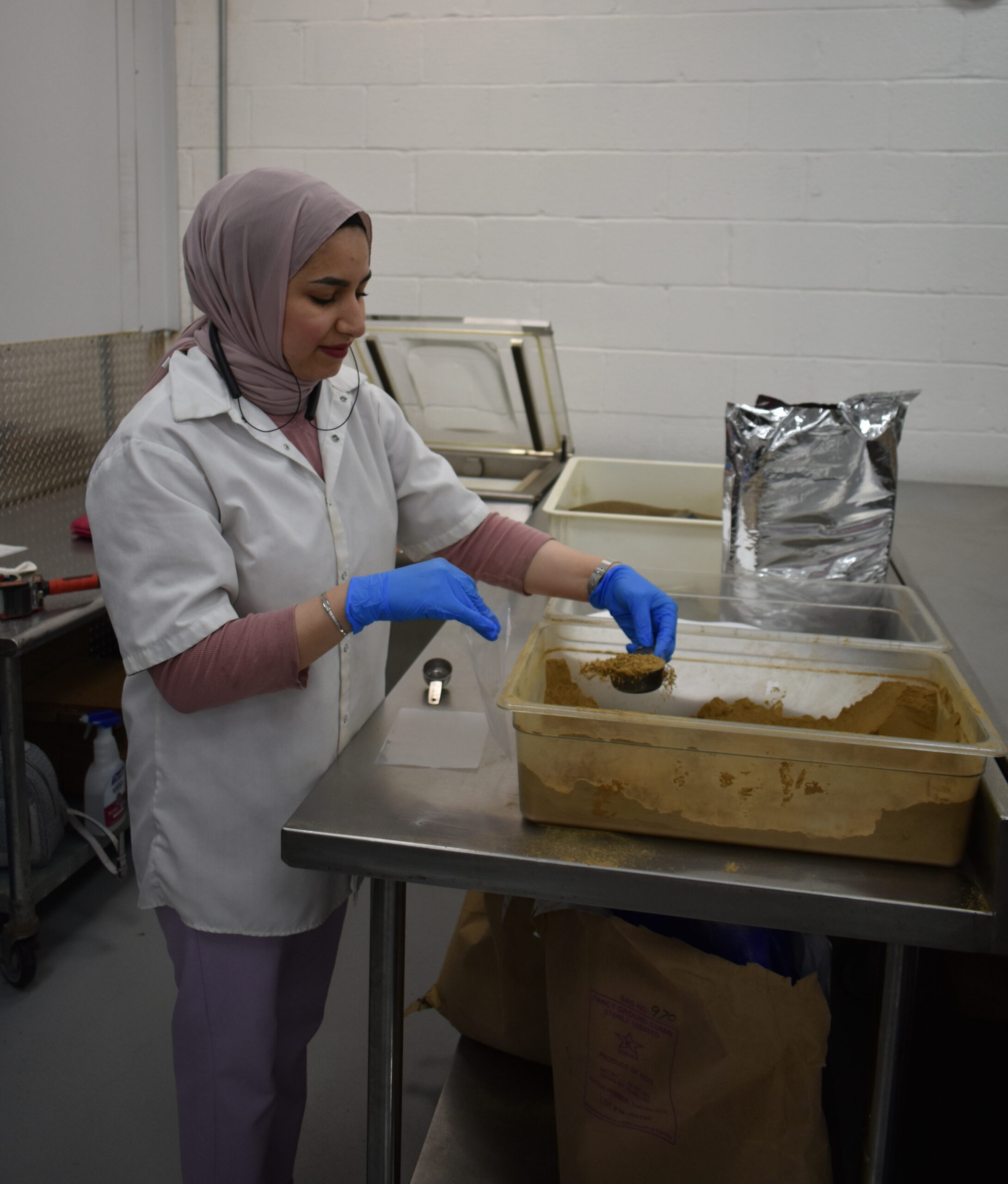 A team member blending Terranean Herbs & Spices za'atar