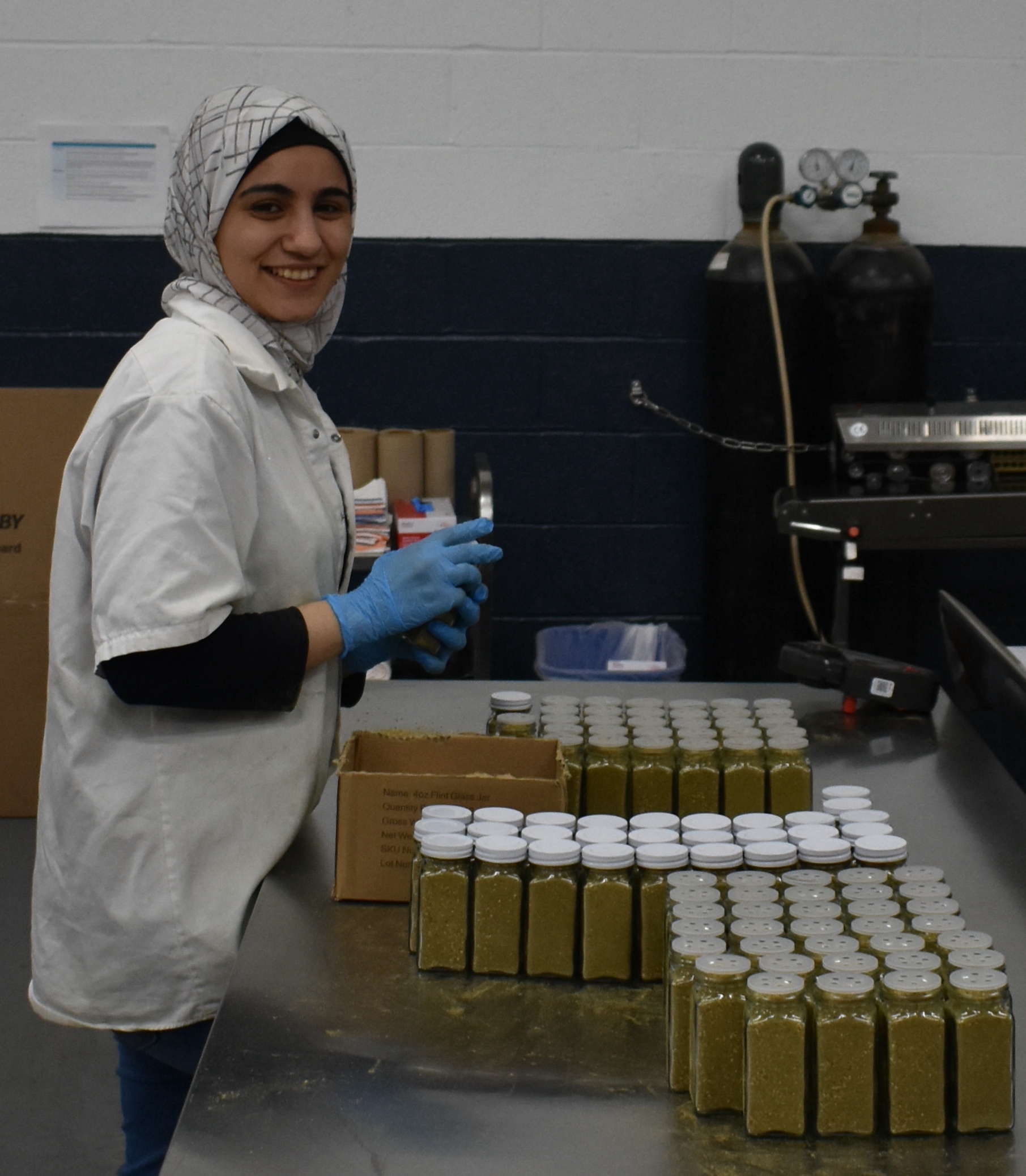 A team member packaging za'atar bottles to be shipped